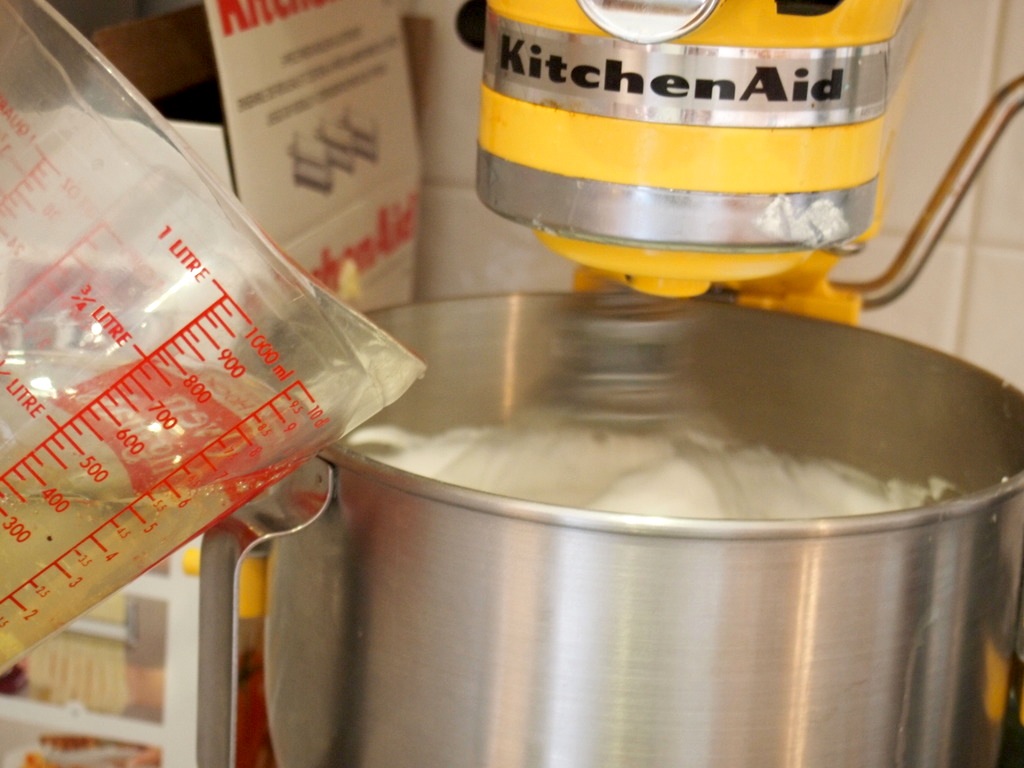 The key to mousseline buttercream: egg whites and syrup combine to make it both fluffy and stable. My mixer, Princess Buttercup, got quite an unladylike workout making 12 cups of this stuff.